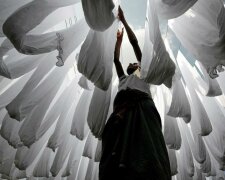A dye factory worker suns fabric after washing them in Narayanganj near Dhaka, Bangladesh, December 25, 2016. REUTERS/Mohammad Ponir Hossain