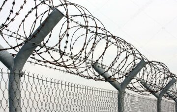 depositphotos_12713198-stock-photo-fence-with-a-barbed-wire