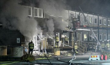 Firefighters extinguish a fire that broke out at a refugee accommodation in Fagersjo, south of Stockholm, Sweden on the night of October 16, 2016. TT News Agency/ Johan Nilsson/via REUTERS