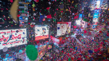 Revelers celebrate the new year as confetti flies over New York's Times Square as seen from the Marriott Marquis, Sunday, Jan. 1, 2017. (AP Photo/Mary Altaffer)