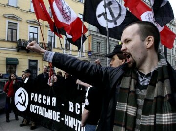 Supporters of the banned National Bolshevik party shout slogans standing with a poster reading &#821