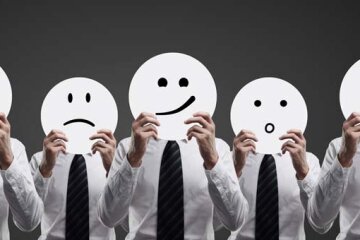 businessmen holding smilies