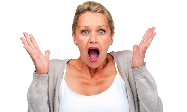 Surprised woman isolated against white background
