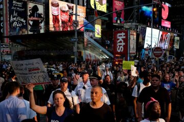 People take part in a protest against the killings of Alton Sterling and Philando Castile during a m